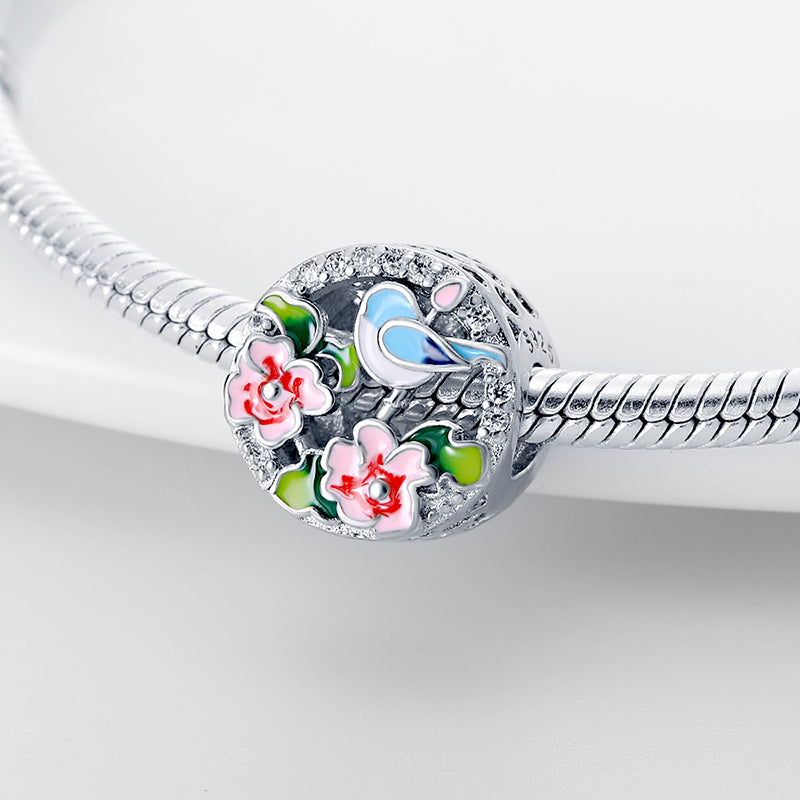 Charm rond oiseau bleu et fleurs roses en argent - Korell charms