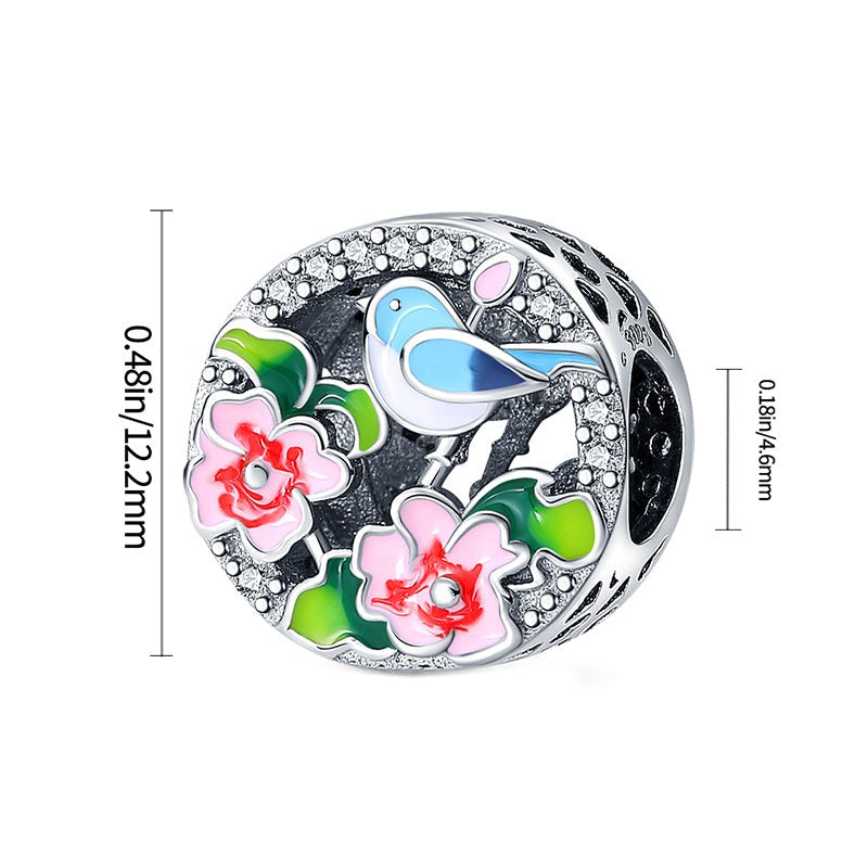 Charm rond oiseau bleu et fleurs roses en argent - Korell charms